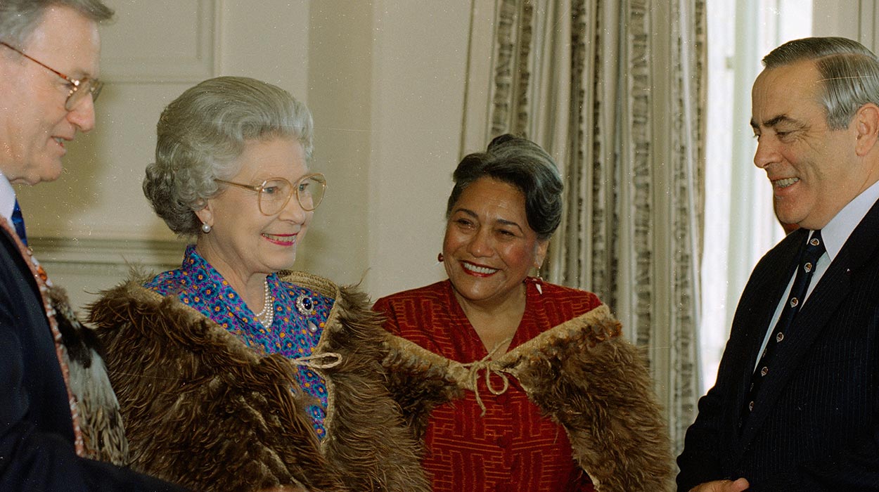 Queen Elizabeth and Dame Te Atairangikaahu with two men on either side.
